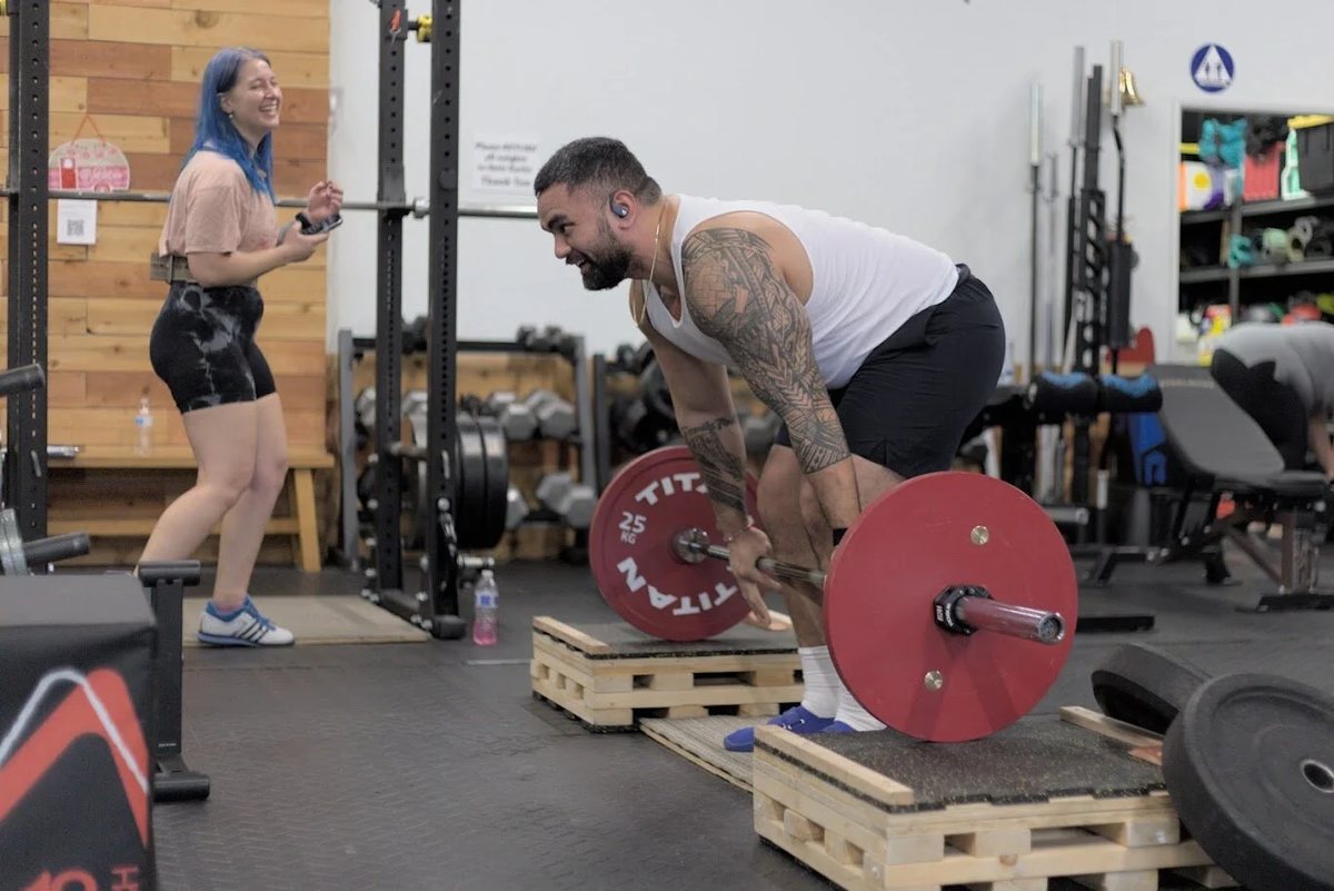 A member pulling a deadlift from blocks at Halls of Strength